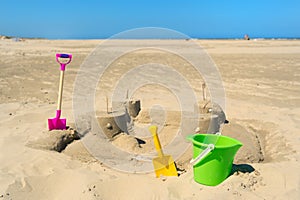 Sand castle with toys at the beach photo