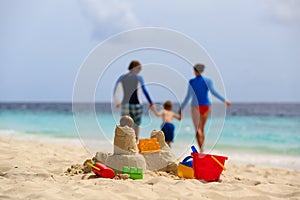 Sand castle on tropical beach, family vacation