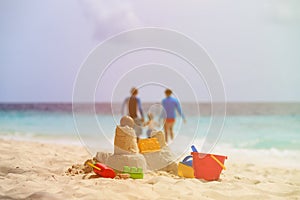 Sand castle on tropical beach, family vacation