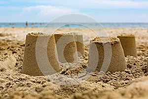 Sand castles on the beach, blue sea Summer holidays concept