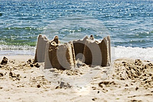 Sand castles on the beach with the sea in the background, s