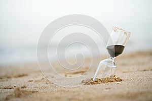 Sand clock on the beach, business time management concept