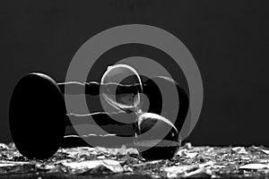 Sand clock on broken glass pieces in blur.