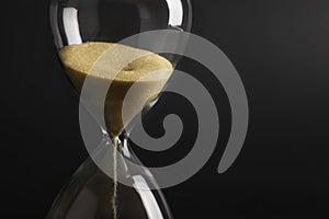 Sand clock , Hourglass as time passing on isolated black background , Life time concept