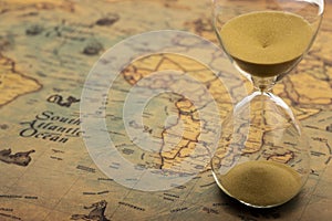 Sand clock , Hourglass as time passing on world map background , Time to travel concept