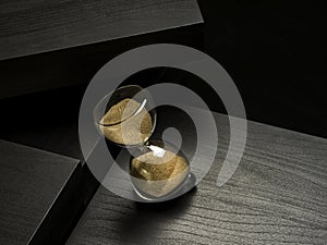 Sand clock over a black background