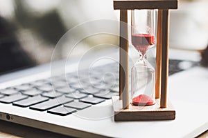 Sand clock timer on laptop .symbol of time