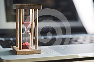 Sand clock timer on laptop .symbol of time