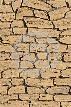 Sand color stone brick beige vertical wall, modern texture ancient pattern background abstract