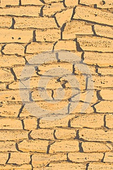 Sand color stone brick yellow vertical wall, modern texture ancient pattern background abstract