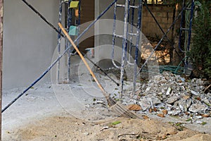 Sand, crushed stones and bloom with scaffold steel in building construction site.