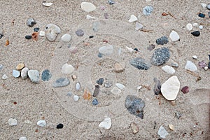 Sand and different stone pebbles on seaside