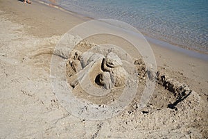 Sand dragon on the beach. Kolympia, Rhodes, Greece