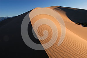 Sand dune arching to horizon photo