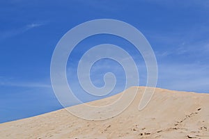 Sand dune in front of blue sky