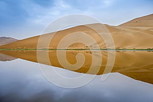 Badain Jaran Desert with lake and reflection