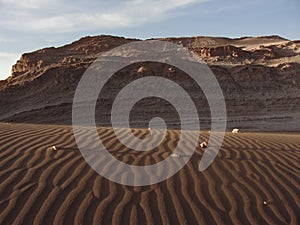 Sand dune and stonewall in Valle de la Luna, Atacama Desert, Chile.