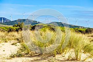 Sand dune and wind turbines on hill, Andalusia Spain