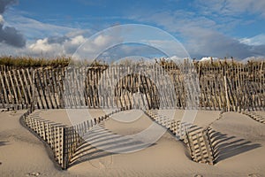Sand dune windswept fences shadows photo