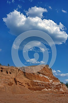 Sand dunes against the blue sky and white clouds.