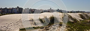 Sand dunes and beachfront buildings at Forte beach. Cabo Frio, Rio de Janeiro, Brazil