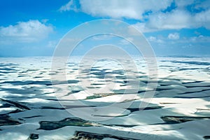 Sand dunes with blue and green lagoons in Lencois Maranhenses photo