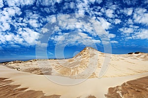 Sand dunes on a blue sky background in the Polish town of Ãâeba. photo