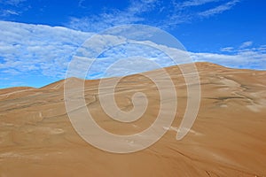 Sand Dunes and Clouds with Blue Skies