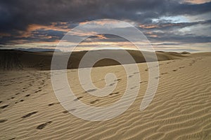 Sand dunes with a cloudy and dark sky