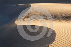 Sand dunes in the desert. Landscape in the daytime. Lines in the sand. Dunes and sky. Summer landscape in the desert.