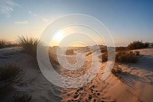 sand dunes in the early morning, with a misty sunrise sky and clear blue skies