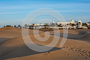 Sand dunes of Maspalomas with a view of the city on Gran Canaria, Spain