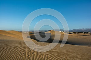 Sand dunes of Maspalomas with a view of the city on Gran Canaria, Spain