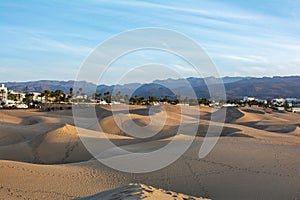 Sand dunes of Maspalomas with a view of the city on Gran Canaria, Spain