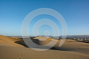 Sand dunes of Maspalomas with a view of the city on Gran Canaria, Spain