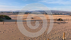 Sand dunes meet the Atlantic Ocean. Top view of Maspalomas sand dunes. Aerial view of Gran Canaria Island. Ocean meets