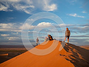 Sand dunes in Morocco, desert landscape, sand texture, tourist camp for night stay, panorama view of sunset over Sahara