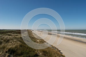 Sand dunes near to the sea with blue sky