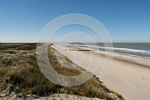 Sand dunes near to the sea with blue sky