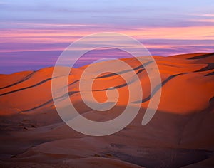 Sand dunes in Sahara desert at sunset