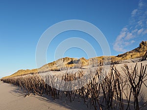 Sand dunes and sandy beach with erosion breakers