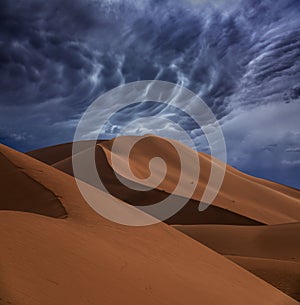 Sand dunes and storm clouds in desert