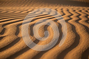 Sand dunes texture with rippled patterns and shadows