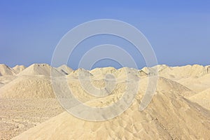 Sand dunes under a clear blue sky