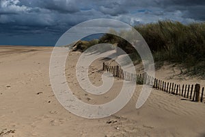 Sand dunes under overcast sky