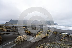 Sand dunes and Vestrahorn mountain during overcast day and soft light. Stokksnes peninsula in Iceland.