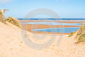 Sand dunes where Norfolk Coast path National Trail from Barnham Overy Staithe reaches the sea