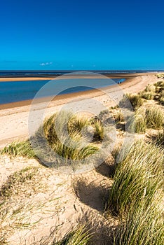 Sand dunes where Norfolk Coast path National Trail from Barnham Overy Staithe reaches the sea