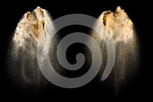 Sand explosion isolated on black background. Freeze motion of sandy dust splash