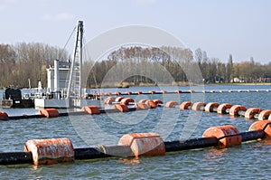 Sand extraction industry in a lake photo